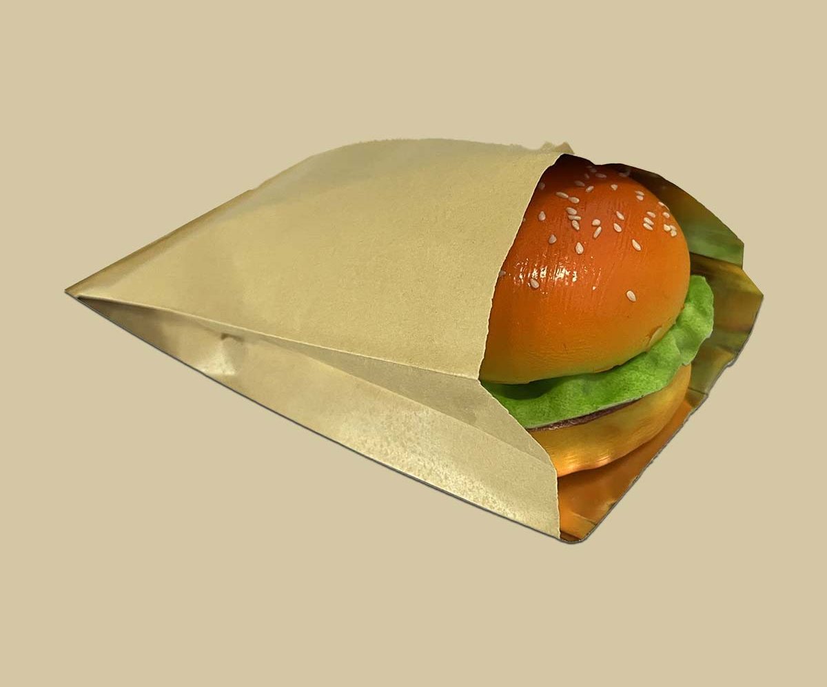Gold foil-lined burger sleeve wrapped around a cheeseburger
