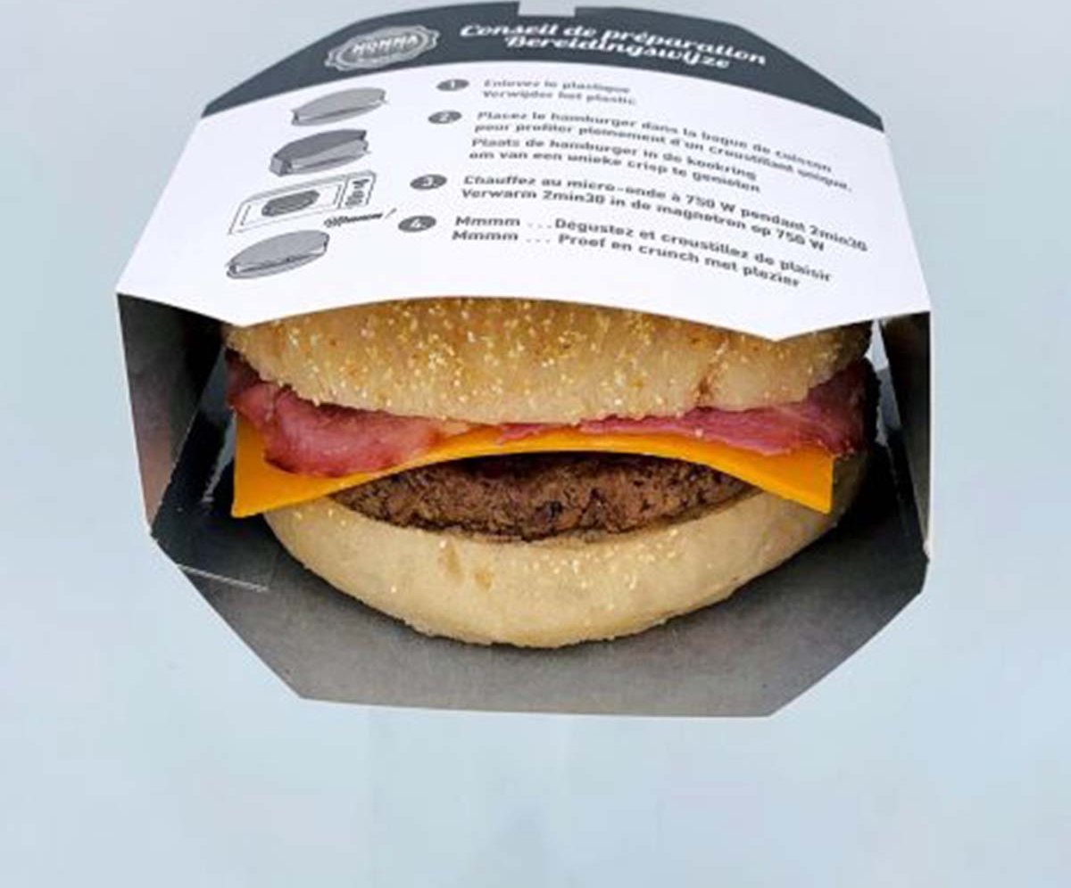 Black and white printed hamburger sleeve holding a stacked burger