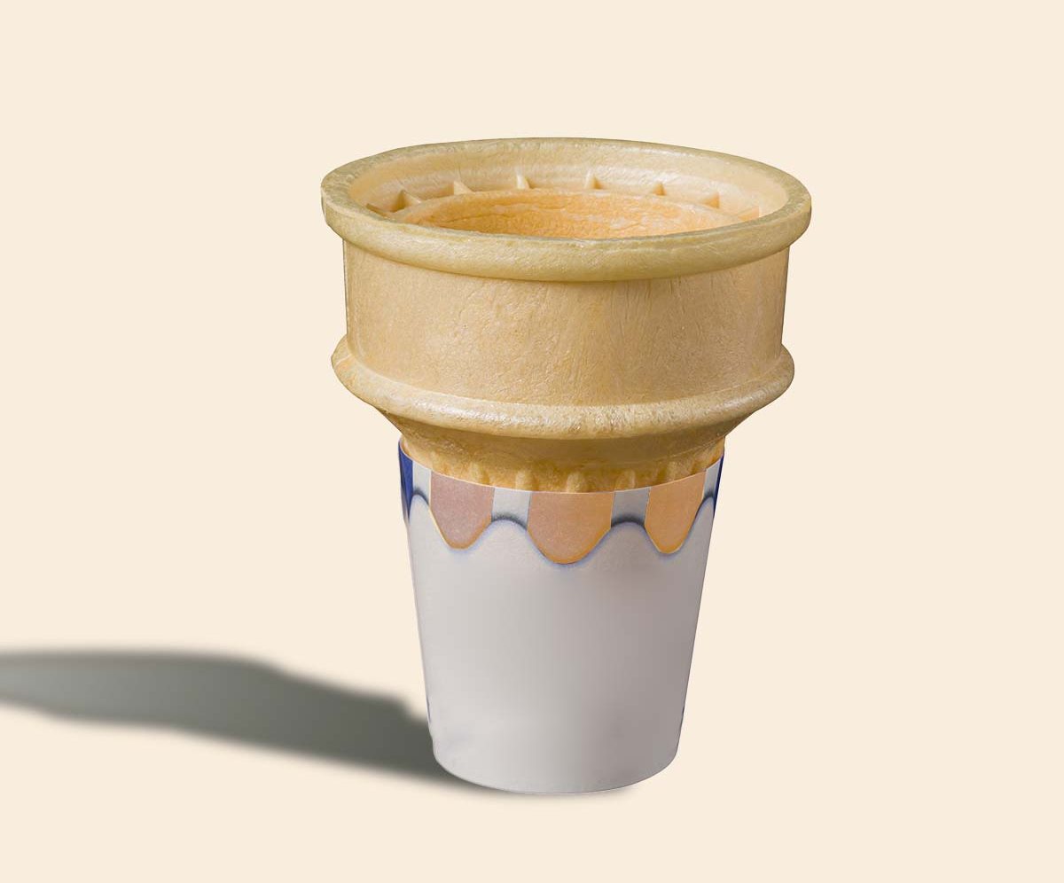 Cake cone sitting in a blue scalloped printed cup sleeve