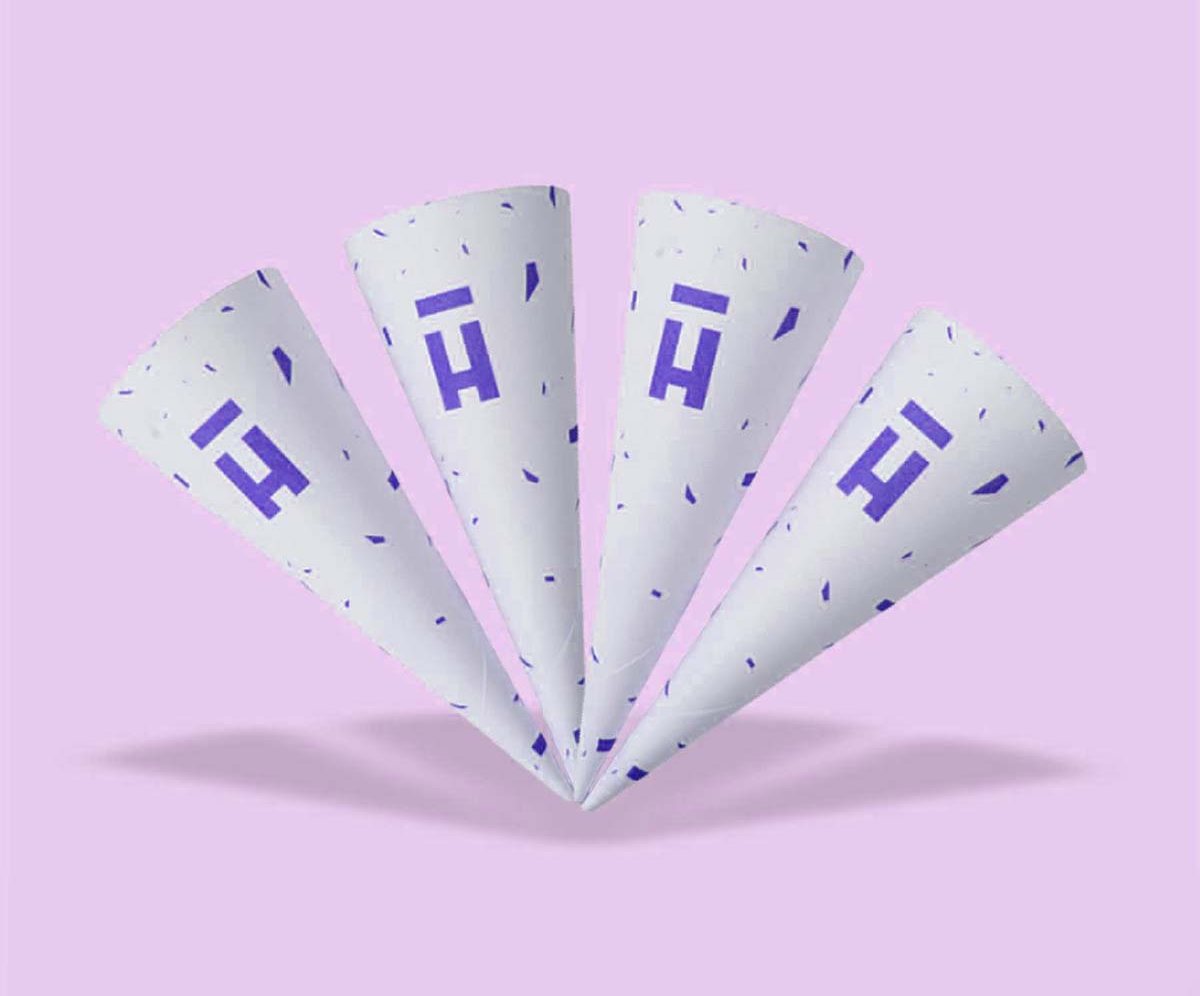 Fan of white cardboard cone sleeves carrying a single monogram