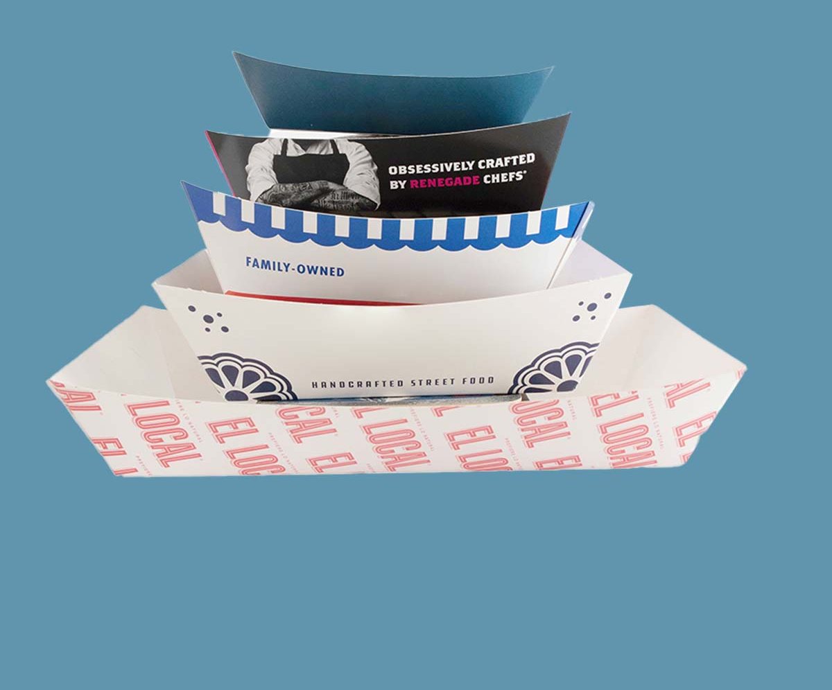 Stack of printed food trays in three sizes on a blue backdrop