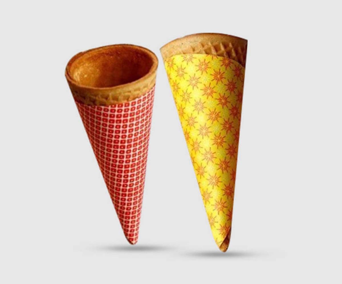 Two short child-size waffle cone sleeves in red and yellow prints