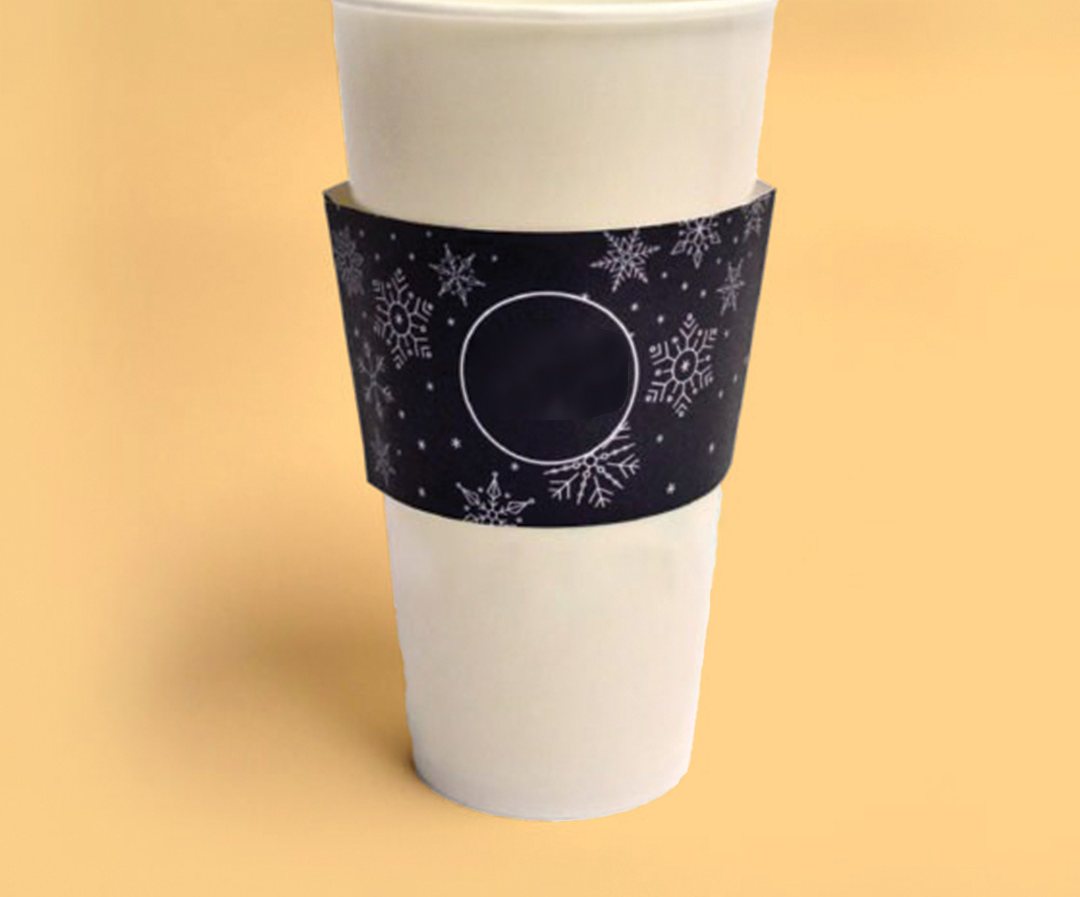 Dark snowflake printed sleeve fitted to a tall white cup