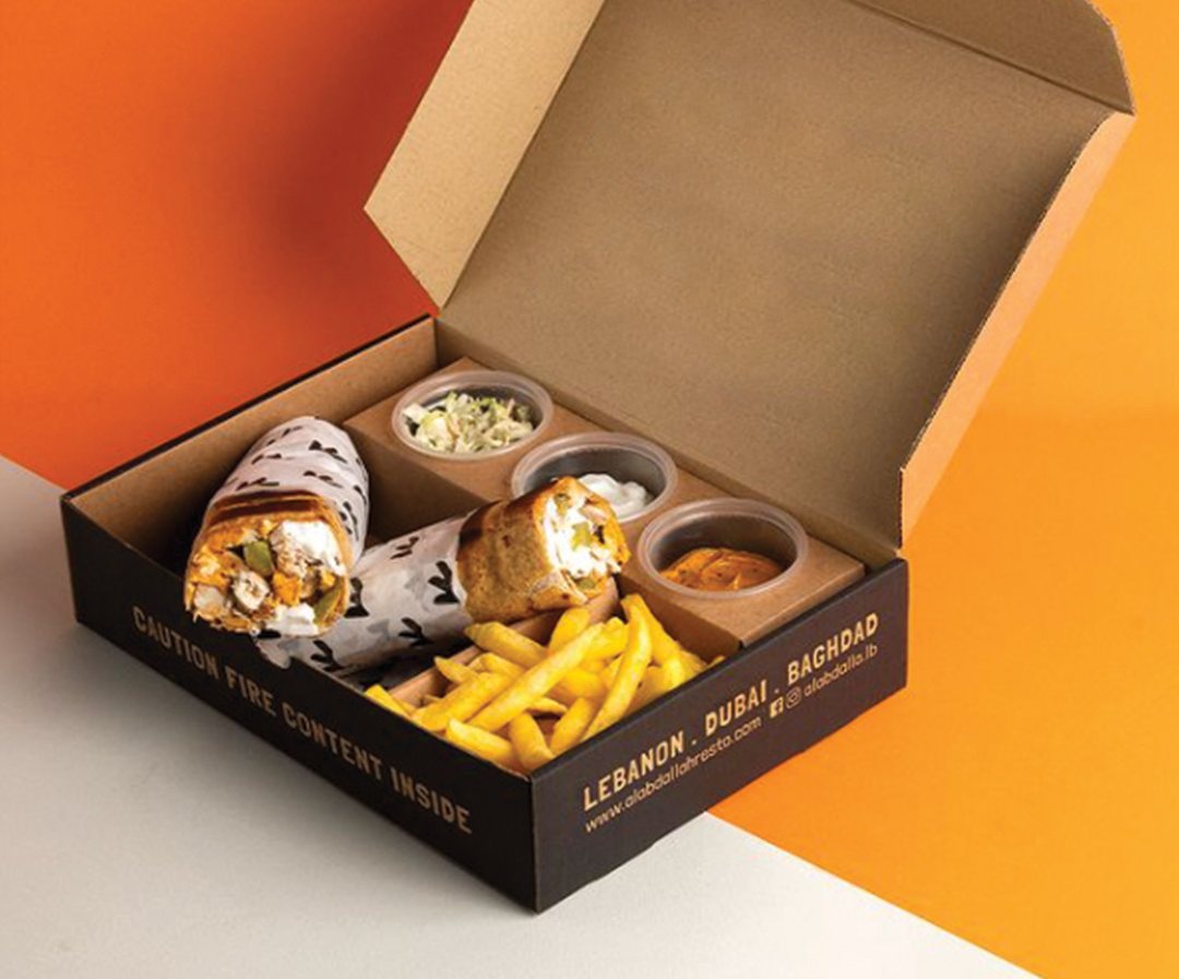 Printed meal tray divided into sections for a main, sides and a dip