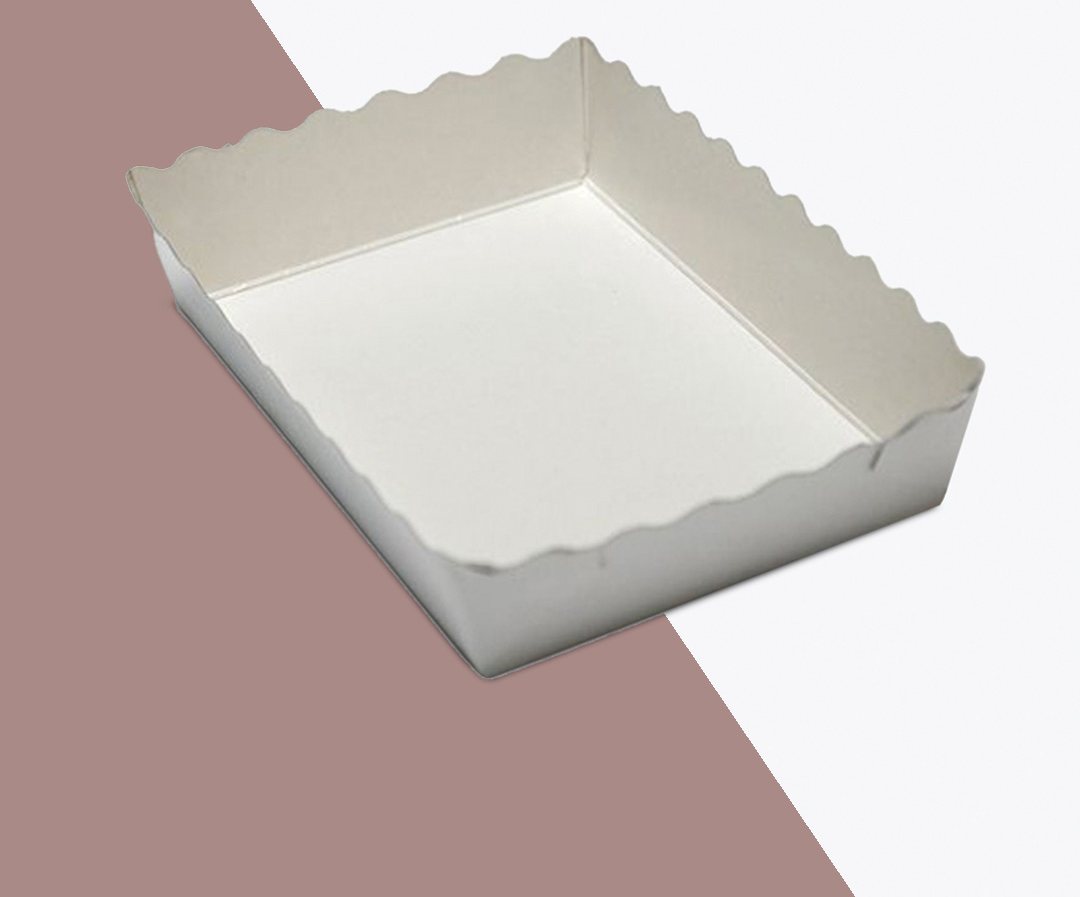 White scalloped dessert tray shown empty on a two-tone backdrop