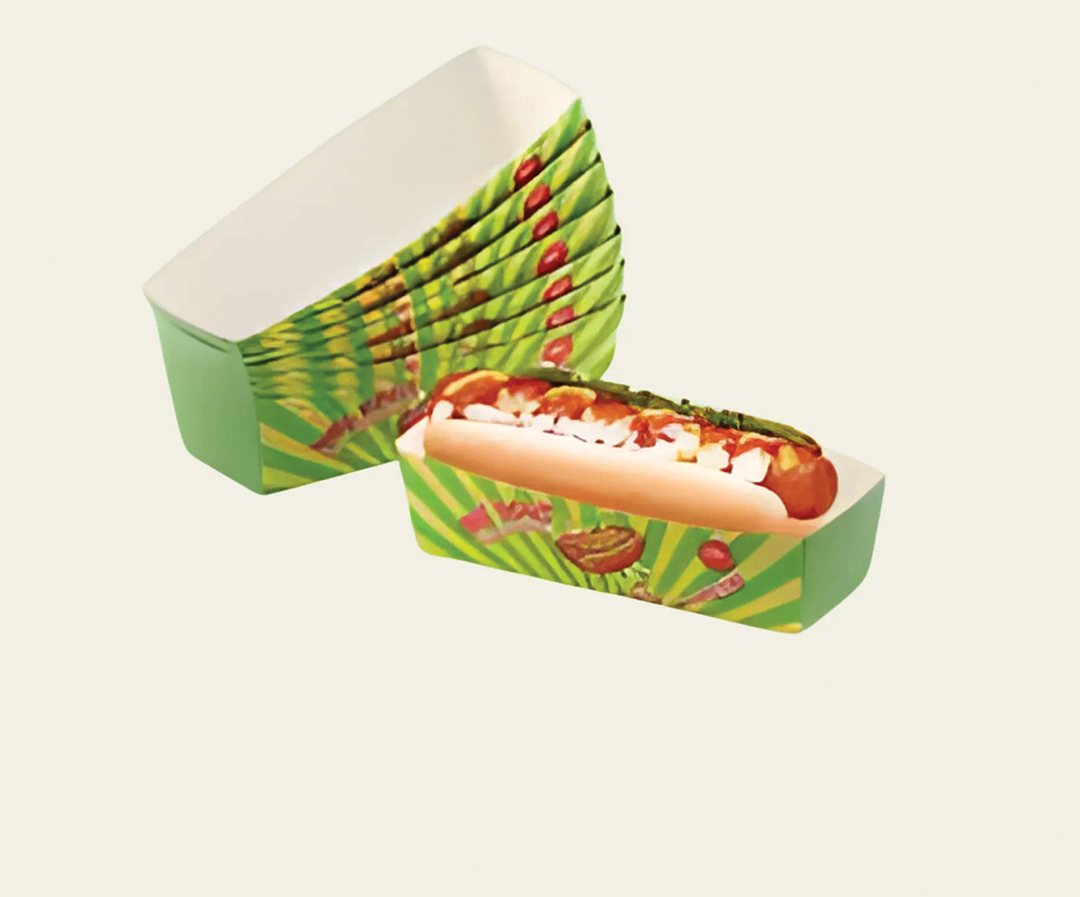 Green and red patterned hot dog tray holding a loaded hot dog