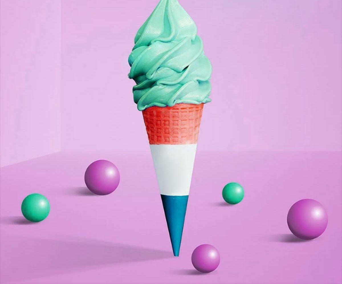 Mint soft-serve held in a red, white and blue printed cone sleeve