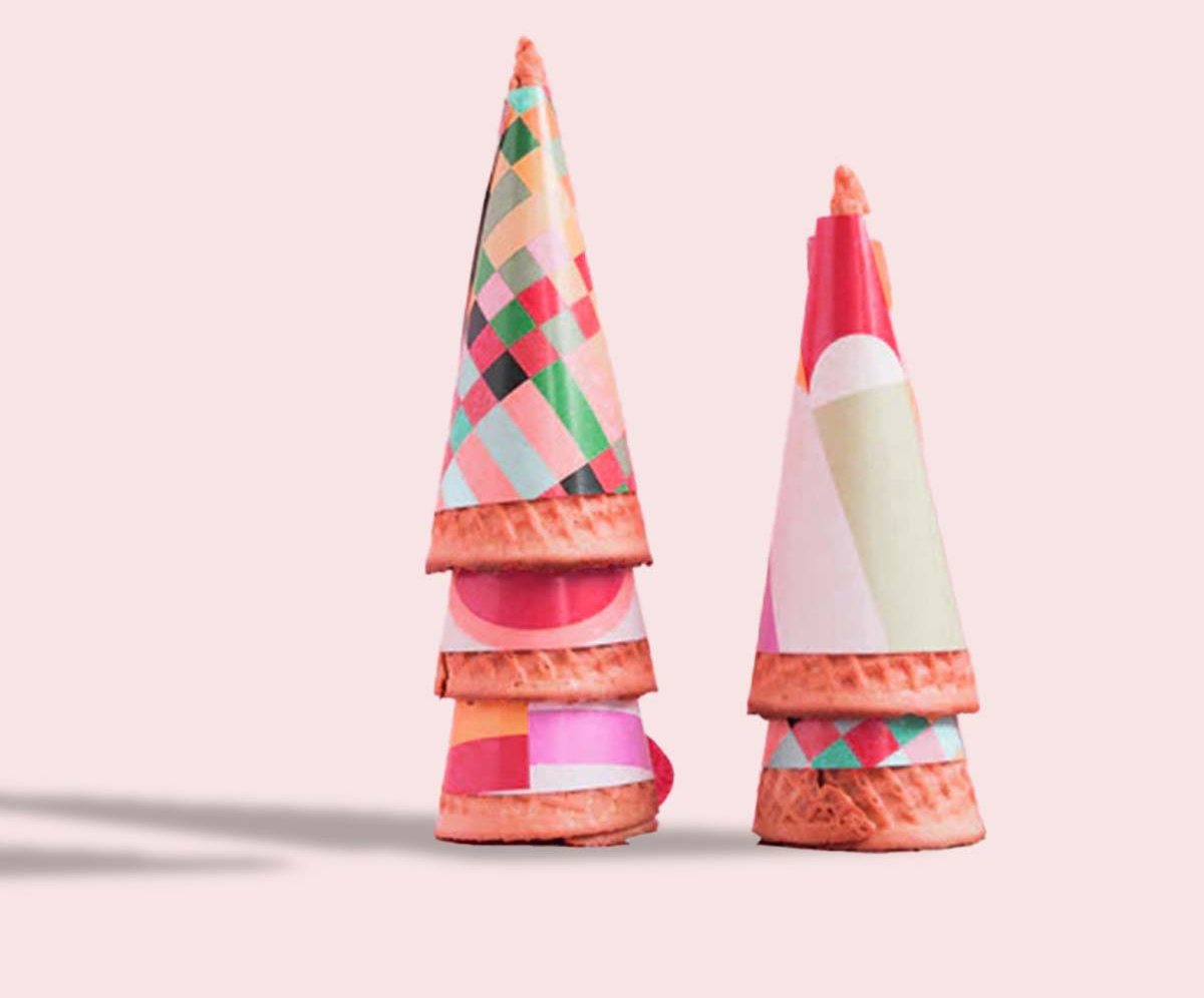 Two patterned cone wrappers stacked on a pale pink backdrop