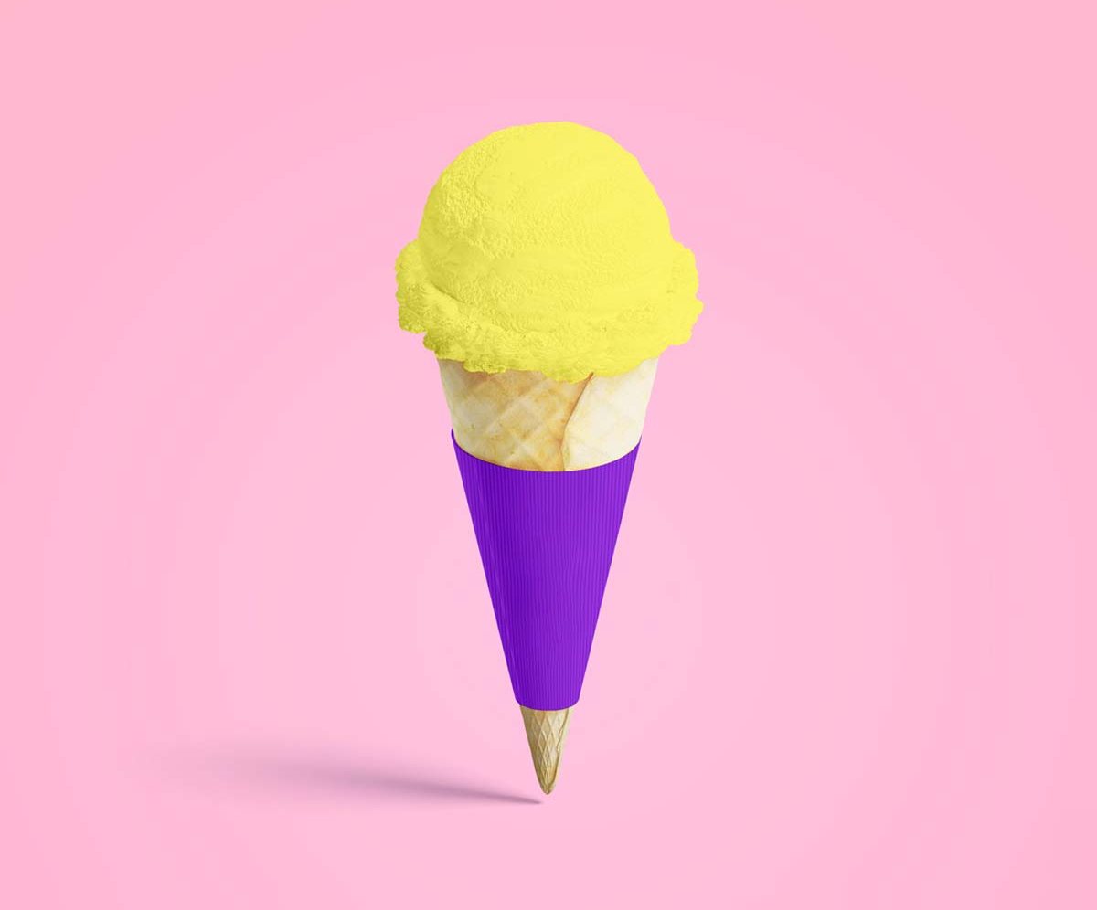 Purple printed cone wrapper holding a scoop of yellow ice cream
