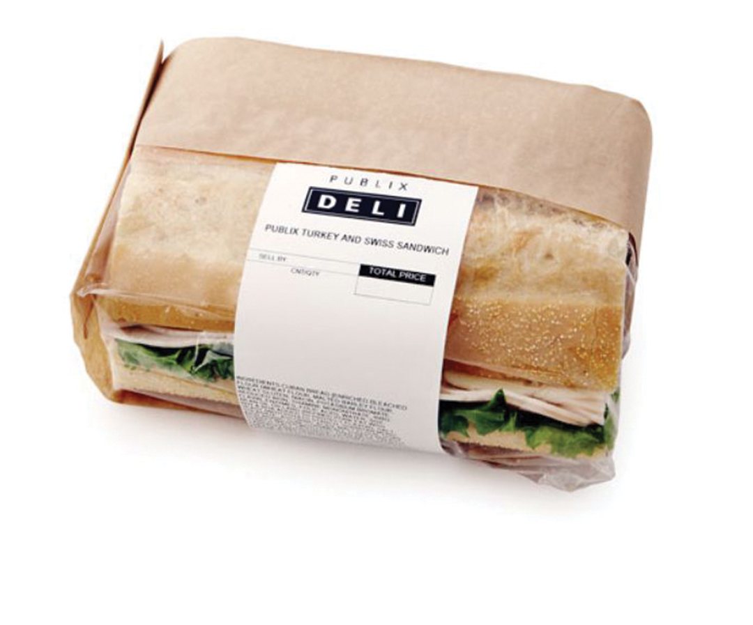 Deli sandwich wrapped in paper and banded with a printed label