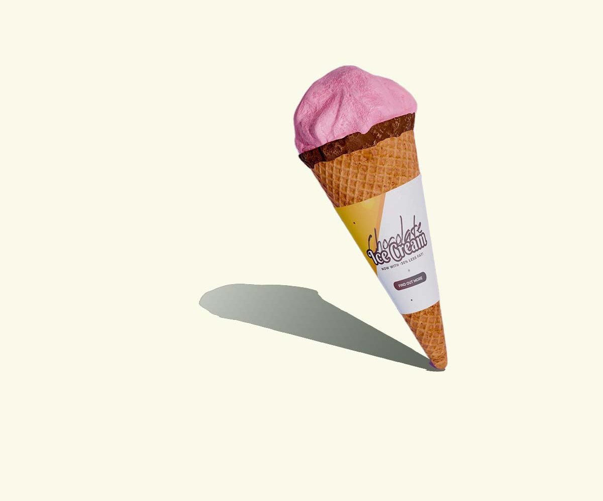 Small rolled cone wrap holding a single scoop of pink gelato