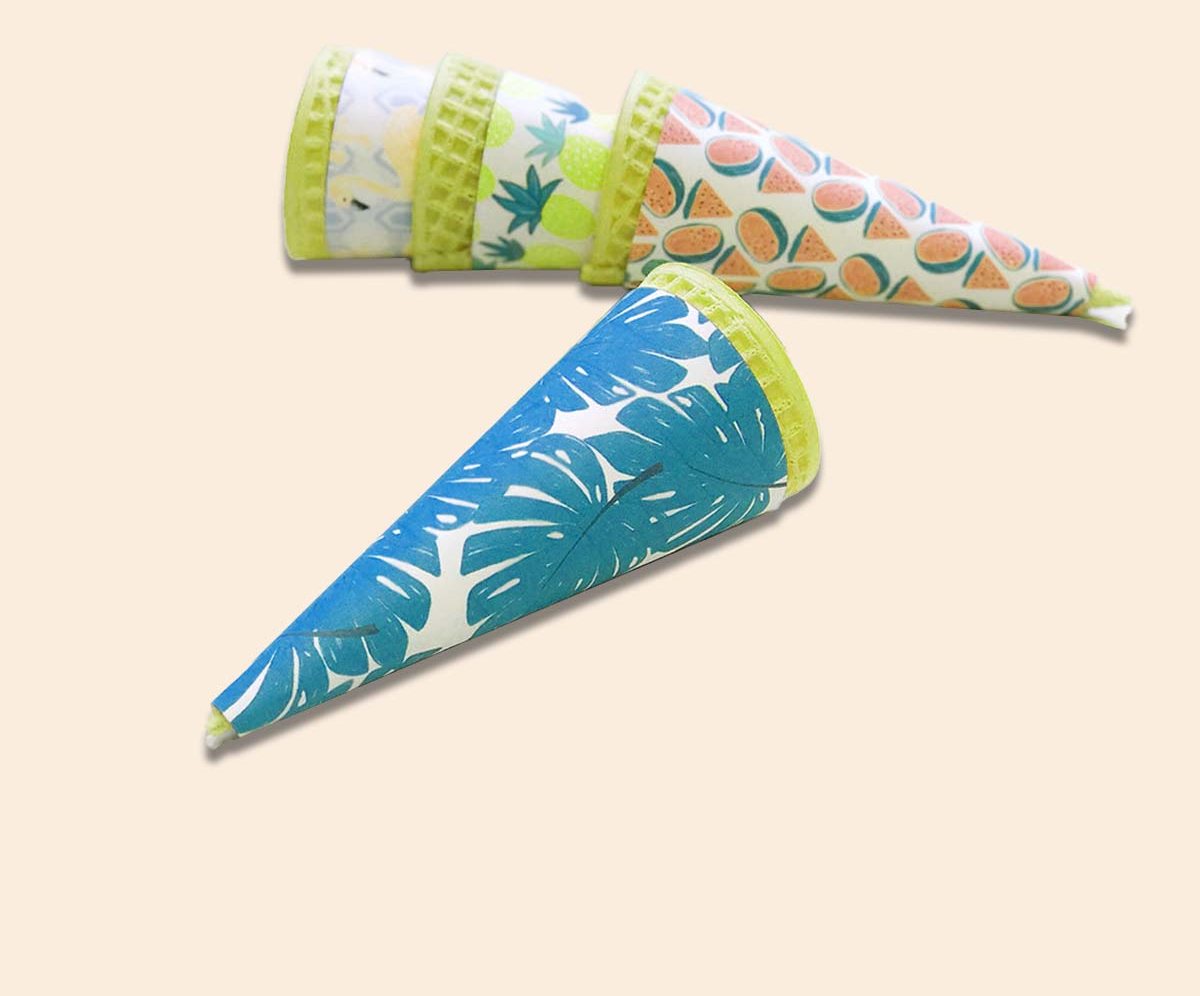 Patterned sugar cone sleeves laid out to show three artwork options