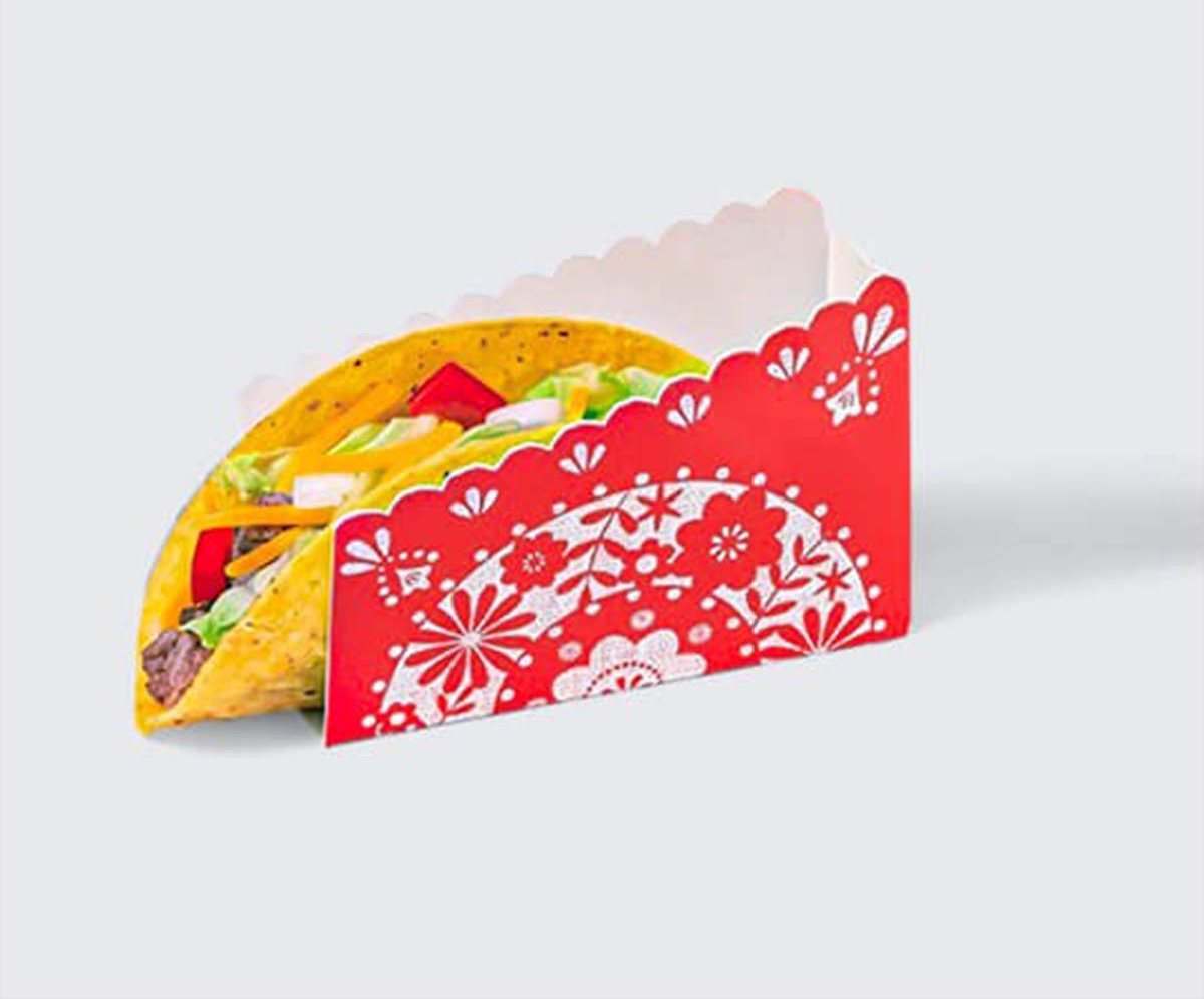 Red patterned taco holder with a decorative papel picado print