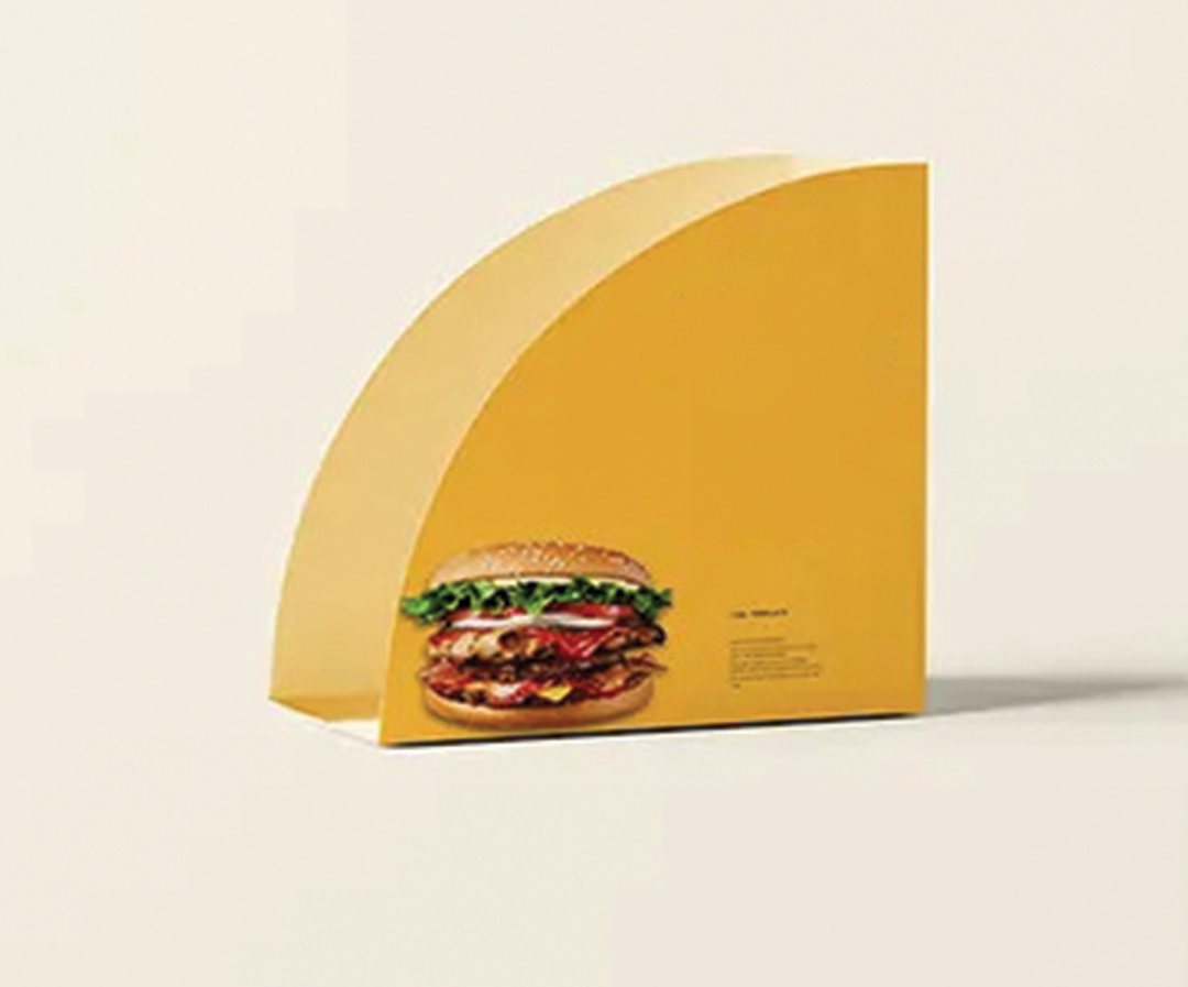 Yellow printed taco holder supporting a loaded hard-shell taco
