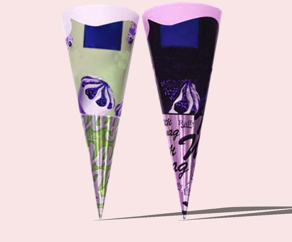 Two navy and purple printed cone sleeves standing on a pink backdrop