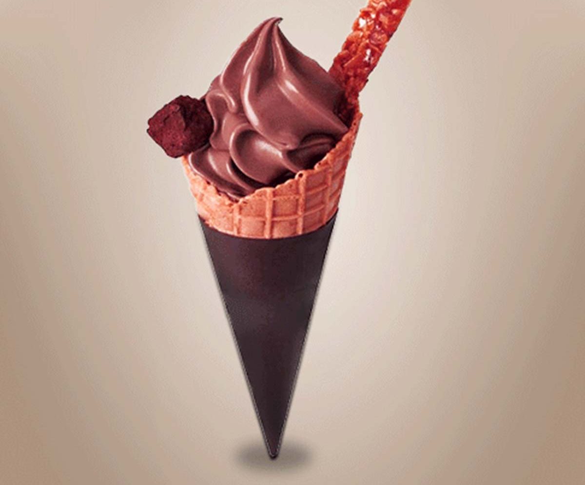 Chocolate dipped waffle cone held in a dark printed sleeve