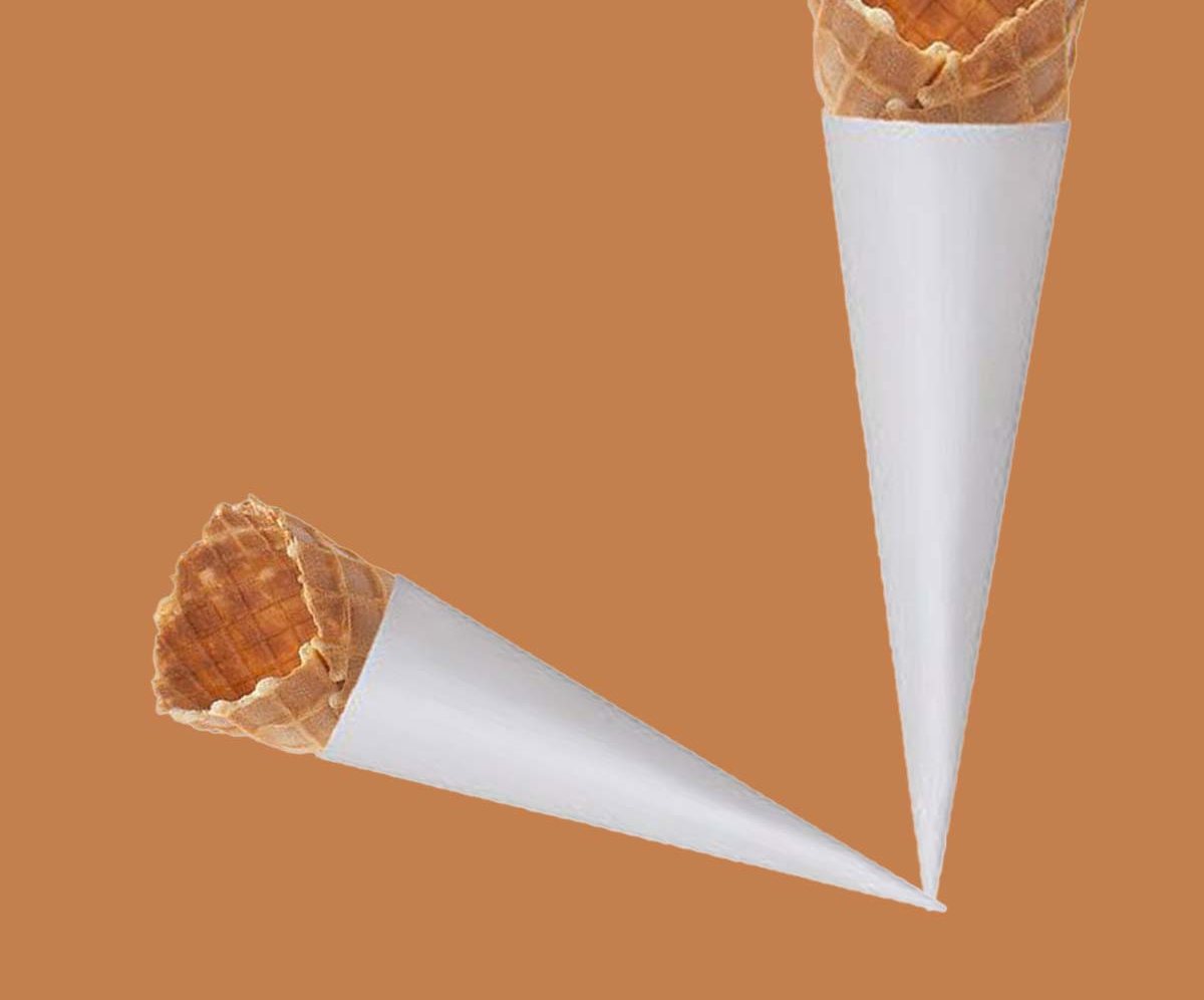Waffle cones dropped into white paper sleeves on an orange backdrop