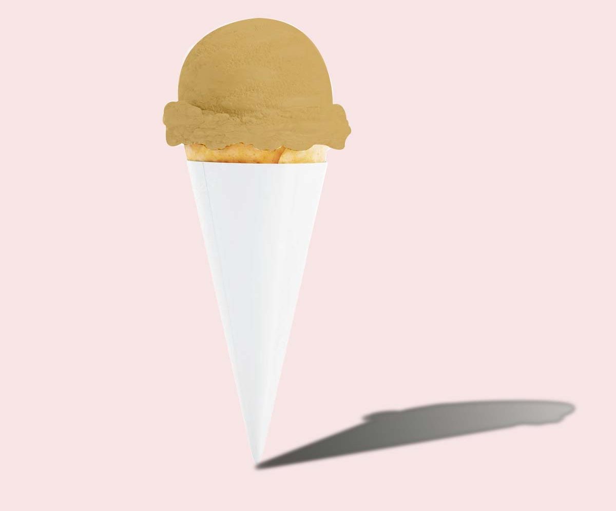 Plain white paper cone sleeve holding a scoop of caramel ice cream