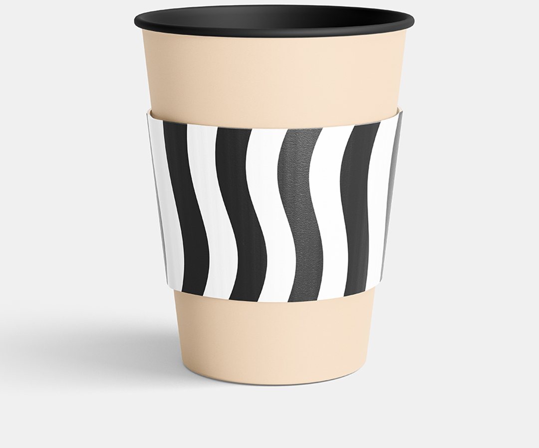 Black and white wave printed beverage sleeve on a cream cup