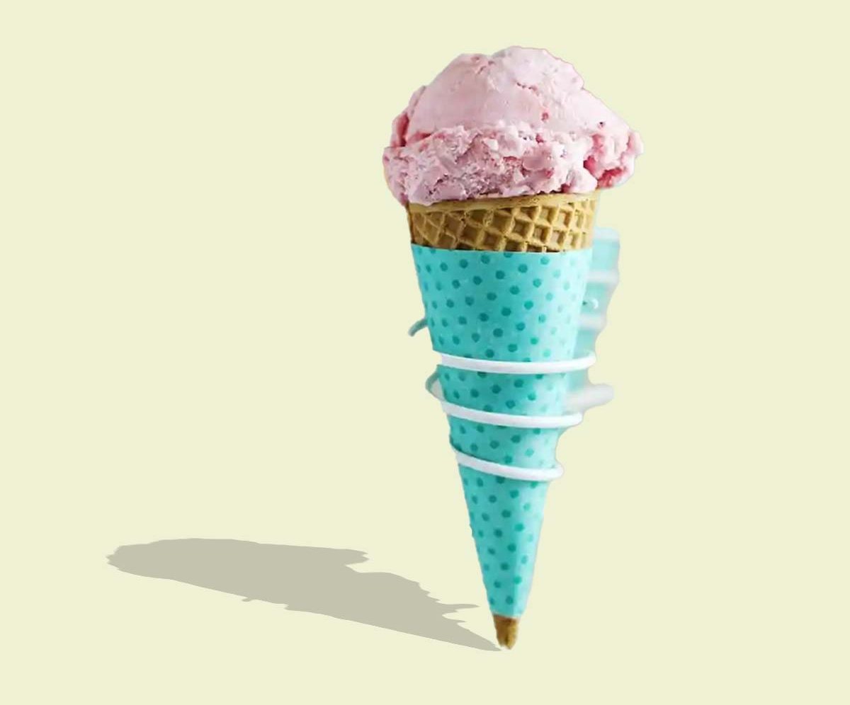 Teal polka dot cone sleeve wrapped around a scoop of strawberry ice cream